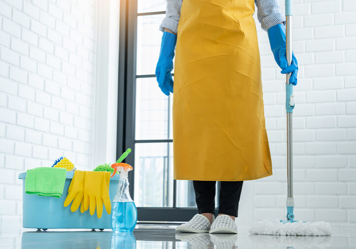 Young housekeeper or washing cleaning floor at mop in protective gloves, Housework Cleaning service